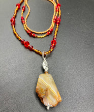 Load image into Gallery viewer, The Vibrant Yellow Agate Natural Stone Red Gold Beaded Choker Style Necklace is a fierce and bold statement piece. Featuring three strands of multi-color glass beads and a mixture of red and gold beads, this jewelry is a perfect addition to any collection. For a complete look, the merchant has created matching earrings. Necklace is 15” in length adjustable to 18" in length. Earrings are 1” length
