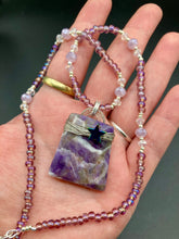 Load image into Gallery viewer, This sophisticated trapezoid-shaped wired amethyst pendant featuring a hematite star bead provides a unique, star-studded night sky look. Multicolored glass beads in shades of pink, purple, blue and gold feature along a single-stranded necklace, intermixed with larger, soft dusty rose glass beads and iridescent beads for a subtle shimmer. Necklace is 17&quot; length can be adjusted to 18&quot; 
