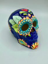 Load image into Gallery viewer, I wanted to create a skully that represented the eternal love for a special kitty cat in your life. Dark royal blue ceramic sugar skull with black cat silhouette is sitting admiring the sun going down. This Day Of The Dead ceramic skull art was created for the cat lovers who adore their sweet kitty. Measurements: H 4” x W 4” x D 5 1/2”

