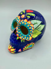Load image into Gallery viewer, I wanted to create a skully that represented the eternal love for a special kitty cat in your life. Dark royal blue ceramic sugar skull with black cat silhouette is sitting admiring the sun going down. This Day Of The Dead ceramic skull art was created for the cat lovers who adore their sweet kitty. Measurements: H 4” x W 4” x D 5 1/2”
