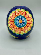 Load image into Gallery viewer, I wanted to create a skully that represented the eternal love for a special kitty cat in your life. Dark royal blue ceramic sugar skull with black cat silhouette is sitting admiring the sun going down. This Day Of The Dead ceramic skull art was created for the cat lovers who adore their sweet kitty. Measurements: H 4” x W 4” x D 5 1/2”
