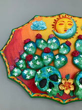 Load image into Gallery viewer, This handcrafted polymer clay wall art features a wood frame painted in a gradient from light yellow to dark red, creating a stunning sunset look. With two bright green skull cactus plant and bright dark red blooming flowers. Featuring a vivid sun and crescent moon with a backdrop of light blue clouds, this frame is sure to make an impression. A bight green hue frame to make a bold contrast with the warm background hue. This piece is sure to make a statement.
