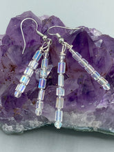 Load image into Gallery viewer, These elegant earrings are crafted with two delicate strands of iridescent rectangular and round glass beads.  Measurements: 1 3/4” in length  
