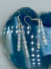 Load image into Gallery viewer, These elegant earrings are crafted with two delicate strands of iridescent rectangular and round glass beads.  Measurements: 1 3/4” in length  

