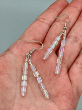 Load image into Gallery viewer, These elegant earrings are crafted with two delicate strands of iridescent rectangular and round glass beads.  Measurements: 1 3/4” in length  
