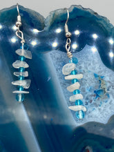Load image into Gallery viewer, A single strand of white moonstone chip beads is accented with small light blue glass beads in these earrings, providing a nature-inspired look with a touch of bohemian vibes. Measurements: 1 1/2” in length 
