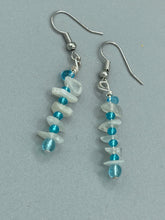 Load image into Gallery viewer, A single strand of white moonstone chip beads is accented with small light blue glass beads in these earrings, providing a nature-inspired look with a touch of bohemian vibes. Measurements: 1 1/2” in length 
