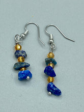 Load image into Gallery viewer, This single-stranded earring features natural lapis stone chips paired with light orange glass beads. Measurements: 1 3/16” in length  
