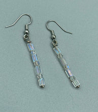 Load image into Gallery viewer, This pair of earrings features two strands of sparkling glass beads, in both rectangular and round shapes, with an iridescent sheen.  Measurements: 1 3/16” in length   
