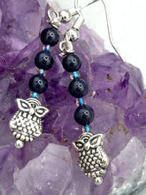 Load image into Gallery viewer, Showcasing shimmery purple goldstone beads, these classy silver-plated owl charm earrings make a statement.  Measurements: 1 3/16” in length
