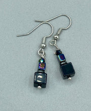 Load image into Gallery viewer, This unique set of earrings features large, square-shaped black obsidian beads accented by small, square hematite beads with flat disk details. It offers a versatile style perfect for any occasion. Measurements: 1” in length

