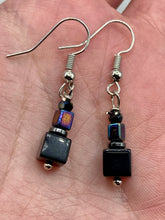 Load image into Gallery viewer, This unique set of earrings features large, square-shaped black obsidian beads accented by small, square hematite beads with flat disk details. It offers a versatile style perfect for any occasion. Measurements: 1” in length
