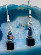 Load image into Gallery viewer, This unique set of earrings features large, square-shaped black obsidian beads accented by small, square hematite beads with flat disk details. It offers a versatile style perfect for any occasion. Measurements: 1” in length
