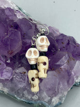 Load image into Gallery viewer, This mini howlite and bone skull bead set of earrings offers a unique touch to any goth, emo, witchy, or Day of the Dead ensemble. The black glass bead accents bring a sophisticated note to the look, and the earrings can easily be dressed up or down.  Measurements: 1 1/4 ” in length  
