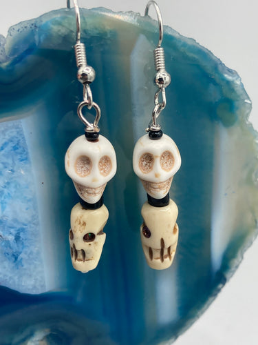 This mini howlite and bone skull bead set of earrings offers a unique touch to any goth, emo, witchy, or Day of the Dead ensemble. The black glass bead accents bring a sophisticated note to the look, and the earrings can easily be dressed up or down.  Measurements: 1 1/4 ” in length  