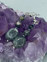 Load image into Gallery viewer, These tourmaline quartz and snowflake obsidian beaded earrings have a cool, neutral tone that's perfect for hippie and boho chic looks. The silver glass beads add a sparkle to any outfit and are ideal for anyone seeking a unique, nature-inspired style.  Measurements: 1 1/2” in length
