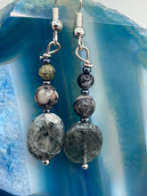 Load image into Gallery viewer, These tourmaline quartz and snowflake obsidian beaded earrings have a cool, neutral tone that's perfect for hippie and boho chic looks. The silver glass beads add a sparkle to any outfit and are ideal for anyone seeking a unique, nature-inspired style.  Measurements: 1 1/2” in length
