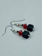 Load image into Gallery viewer, This eye-catching piece features two unconventional components: a large square-shaped black obsidian bead and a large, dark red glass bead. With the beautiful interplay of colors and shapes, these earrings are truly unique, yet at the same time, versatile enough to be paired with a range of styles. Measurements: 1” in length 

