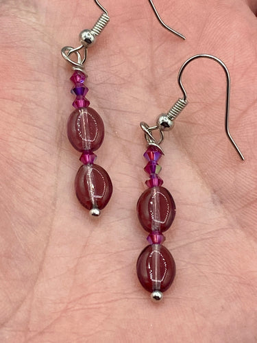 These delicate earrings feature light purple and tiny fuchsia glass beads, which offer a range of beautiful hues, such as blue, green, pink and gold. With a versatile style, these earrings will enhance any ensemble.  Measurements: 1 1/2” in length 