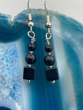 Load image into Gallery viewer, These earrings are crafted with large square-shaped black obsidian beads and small round-shaped black obsidian beads, paired with light gray glass beads. This combination provides an eye-catching, yet versatile look. Measurements: 1” in length

