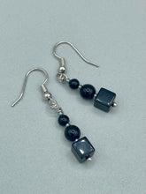 Load image into Gallery viewer, These earrings are crafted with large square-shaped black obsidian beads and small round-shaped black obsidian beads, paired with light gray glass beads. This combination provides an eye-catching, yet versatile look. Measurements: 1” in length
