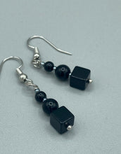 Load image into Gallery viewer, These earrings are crafted with large square-shaped black obsidian beads and small round-shaped black obsidian beads, paired with light gray glass beads. This combination provides an eye-catching, yet versatile look. Measurements: 1” in length
