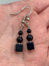 Load image into Gallery viewer, These earrings are crafted with large square-shaped black obsidian beads and small round-shaped black obsidian beads, paired with light gray glass beads. This combination provides an eye-catching, yet versatile look. Measurements: 1” in length

