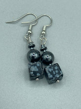 Load image into Gallery viewer, These earrings feature large square shape snowflake obsidian beads complemented with round hematite beads. The neutral cool tones of the stone beads create a unique and versatile style. Measurements: 1 1/4” in length
