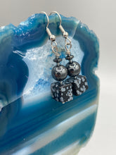 Load image into Gallery viewer, These earrings feature large square shape snowflake obsidian beads complemented with round hematite beads. The neutral cool tones of the stone beads create a unique and versatile style. Measurements: 1 1/4” in length
