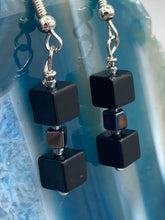 Load image into Gallery viewer, This pair of earrings features two large square-shaped black obsidian beads and small square-shaped hematite beads. With its distinct yet versatile look, this item is sure to make a statement. Measurements: 1” in length
