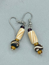 Load image into Gallery viewer, This earring set features cylinder and round bone beads with decorative wavy lines and dot designs, as well as gold-tone glass beads. Neutral colors make these earrings perfect for any occasion - dress them up or down for a look that is sure to be one-of-a-kind.  Measurements: 1 5/8 ” in length  

