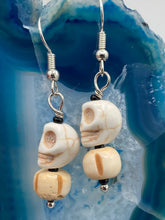 Load image into Gallery viewer, These handcrafted Mini Howlite Skull Bead and Bone Carved Bead Earrings will give any goth, emo, or witchy outfit an extra special touch. Perfect for Day of the Dead celebrations or any casual occasion, these unique earrings will make any look stand out.  Measurements: 1 1/4 ” in length  
