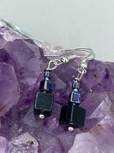 Load image into Gallery viewer, These eye-catching earrings feature a unique combination of large square-shaped black obsidian beads and two small square hematite beads, drawing inspiration from nature to give you a bohemian, hippie vibe. Perfect for a shabby chic, boho chic look. Measurements: 1” in length
