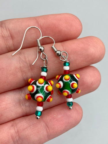 Vibrant color bumpy round lampworked glass bead set of earrings. Colorful green, white, red, and bright yellow festive piñata shaped bead.  This also reminds me of the shape of a virus. Either way, this is a super fun, unique, bold piece of jewelry, it's sure to make a statement piece.  Measurements: 1 1/4” in length