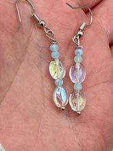 Load image into Gallery viewer, Elevate your style with these simple yet dainty beaded earrings boasting a gentle iridescent and frosty light blue hue. Perfectly versatile, they will add a refined touch to any outfit.  Measurements: 1 1/4” in length
