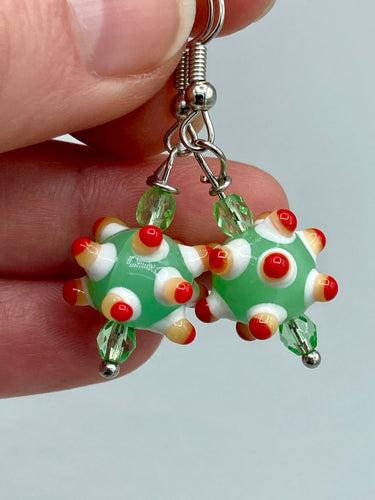 Vibrant color bumpy round lampworked glass bead set of earrings. Colorful light green, white, yellow, and bright red festive piñata shaped bead.  This also reminds me of the shape of a virus. Either way, this is a super fun, unique, bold piece of jewelry, it's sure to make a statement piece.  Measurements: 1 1/4” in length