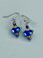 Load image into Gallery viewer, This eye-catching set of earrings features a vibrant color palette of bumpy round lampworked glass beads. The deep cobalt blue, white, light blue, and light yellow fiesta piñata-shaped bead make it truly unique, while the virus-like shape makes it stand out. A bold statement piece, these earrings will surely turn heads. Measurements: 1 1/4” in length 
