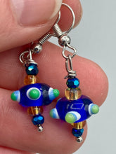 Load image into Gallery viewer, This eye-catching set of earrings features a vibrant color palette of bumpy round lampworked glass beads. The deep cobalt blue, white, light blue, and light yellow fiesta piñata-shaped bead make it truly unique, while the virus-like shape makes it stand out. A bold statement piece, these earrings will surely turn heads. Measurements: 1 1/4” in length 
