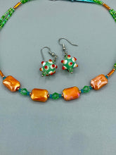 Load image into Gallery viewer, This unique, double-strand necklace consists of a blend of glass beads, including multi-green and rectangular, faceted orange glass beads, and is accented with gold and light blue elements. The vibrant combination is perfect for any summer look and will enhance any outfit.  Measurements:  Necklace is 16” and can be adjusted up to 18&quot;
