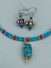 Load image into Gallery viewer, Vibrant color bumpy round lampworked glass bead set of earrings. Colorful teal, white, yellow, and bright orange festive piñata shaped bead.  This also reminds me of the shape of a virus. Either way, this is a super fun, unique, bold piece of jewelry, it&#39;s sure to make a statement piece.  Measurements: 1” in length
