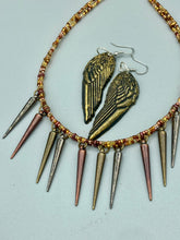 Load image into Gallery viewer, A copper-toned, adjustable Steampunk-style glass beaded necklace is detailed with sharp-drop metal plated hanging beads. Bright orange rectangular tube beads mix with other shapes for an eye-catching effect, while double-hole flat matte copper-toned beads provide a collar finish which makes this piece drape elegantly across the neck. Sparkling gold tone angel wings earrings made of polymer clay.  These earrings are designed to face forward when worn instead of the front wings showing on the side.
