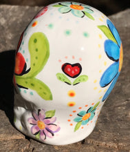 Load image into Gallery viewer, This Mini Floral Ceramic Sugar Skull pays homage to the Dia De Los Muertos tradition. Featuring a vibrant red and yellow flower inspired by a trip to the D.C. Arboretum, this piece of Day Of The Dead Skull Art is a wonderful way to honor those dearly departed. The perfect addition to any home. Measurements: H 2 3/4” x W 2” x D 2”
