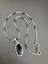 Load image into Gallery viewer, This dainty necklace is full of black and silver shimmery glass beads. A length black oval shaped glass bead hangs low to add length to this necklace.  It&#39;s the perfect necklace to add a little elegance to any outfit. Will go with any outfit, dress it up or down, this necklace will complete any look. This beauty is a must-have, add it to your jewelry collection.  Measurements: Necklace is 15 1/2” adjustable up to 18&quot;- pendant is 1 1/2” Height
