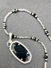 Load image into Gallery viewer, This dainty necklace is full of black and silver shimmery glass beads. A length black oval shaped glass bead hangs low to add length to this necklace.  It&#39;s the perfect necklace to add a little elegance to any outfit. Will go with any outfit, dress it up or down, this necklace will complete any look. This beauty is a must-have, add it to your jewelry collection.  Measurements: Necklace is 15 1/2” adjustable up to 18&quot;- pendant is 1 1/2” Height
