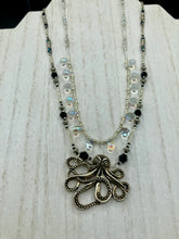 Load image into Gallery viewer, This Steampunk Metal Octopus Double Strand Bead Adjustable Necklace is a stylish and unique addition to any collection. Crafted with vivid iridescent teardrop and glass beads, this stylish jewelry also features a highly detailed metal octopus pendant. Strands of beads are designed to interweave without tangling for a truly eye-catching look.   Measurements:  Necklace measures 16 1/2” adjustable up to 18”
