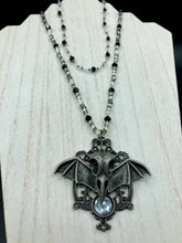 Load image into Gallery viewer, Dark Elegant Black, Gray, Silver Collar Style Adjustable Glass Beaded Necklace is the ultimate vampire goth jewelry statement piece to add to your jewelry collection. Metal raven skull with highly detailed bat wings. This beautiful necklace has a dark tone death raven theme, both is a unique and bold piece of jewelry. Necklace is 14 1/2” adjustable up to 18&quot; in length - nickel free metal ravel skull pendant 2 3/4&quot;

