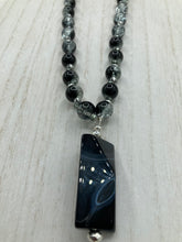 Load image into Gallery viewer, This black agate natural stone necklace features a unique rectangular pyramid shape and multi-colored glass beads. Perfect for all kinds of looks, from cocktail attire to shabby chic to elegant goth styles, this necklace is as versatile as it is stylish and will complete any outfit. The set includes matching earrings, making it a must-have addition to any jewelry collection.  Measurements:  Necklace is 18 1/2” 
