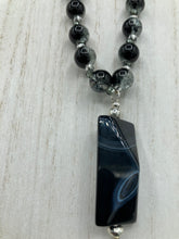 Load image into Gallery viewer, This black agate natural stone necklace features a unique rectangular pyramid shape and multi-colored glass beads. Perfect for all kinds of looks, from cocktail attire to shabby chic to elegant goth styles, this necklace is as versatile as it is stylish and will complete any outfit. The set includes matching earrings, making it a must-have addition to any jewelry collection.  Measurements:  Necklace is 18 1/2” 
