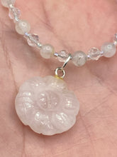 Load image into Gallery viewer, This elegant necklace is adorned with a beautiful rose quartz pendant featuring an intricate floral cutout, complemented by small round rose quartz beads with an iridescent glass finish.  Measurements:  Necklace is 18 1/2”
