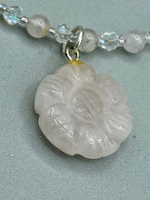 Load image into Gallery viewer, This elegant necklace is adorned with a beautiful rose quartz pendant featuring an intricate floral cutout, complemented by small round rose quartz beads with an iridescent glass finish.  Measurements:  Necklace is 18 1/2”
